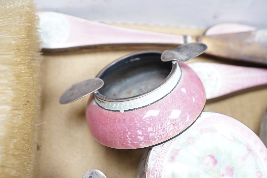 An early century North American sterling and enamel dressing table set by Theodore W. Foster & Bro, comprising fourteen items including hand mirror, 29.1cm, brushes, trinket box, nail buffer on stand, toilet jars, powder